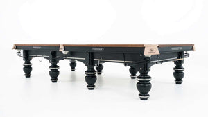 Rasson Strong II 12ft snooker table at an angle, showing the pocket plates and black leg frame
