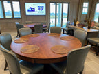 Round poker table with the optional dining top fitted, set for dinner with chairs