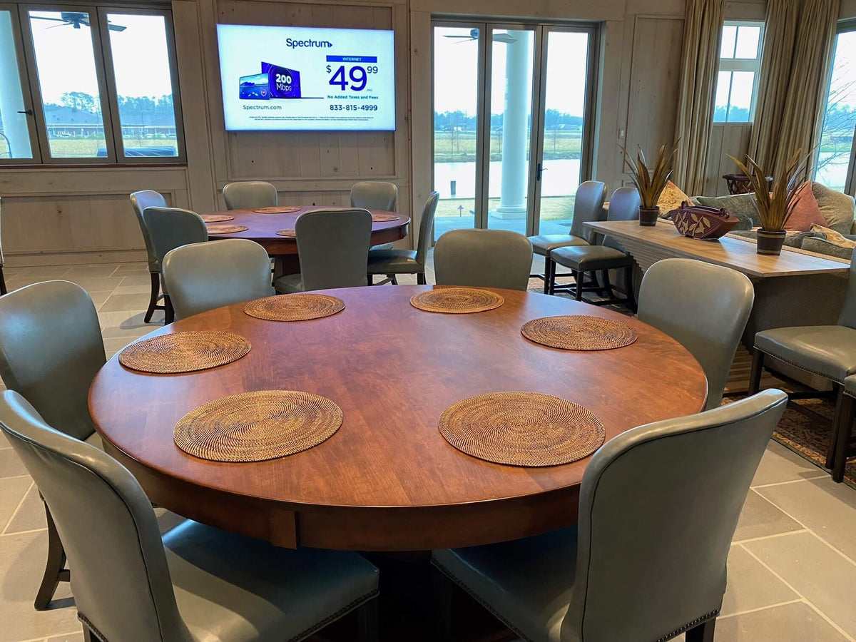 Round poker table with the optional dining top fitted, set for dinner with chairs
