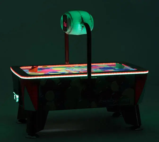 SAM Baby Evo air hockey table glowing with green LED lighting