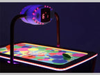 Close-up of the SAM Baby Evo overhead scorer and bright spotted playfield in the dark