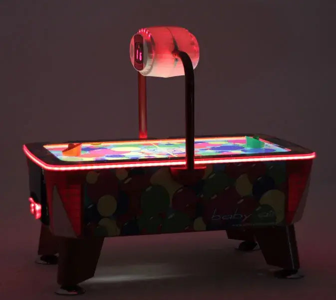 SAM Baby Evo air hockey table glowing with red LED lighting