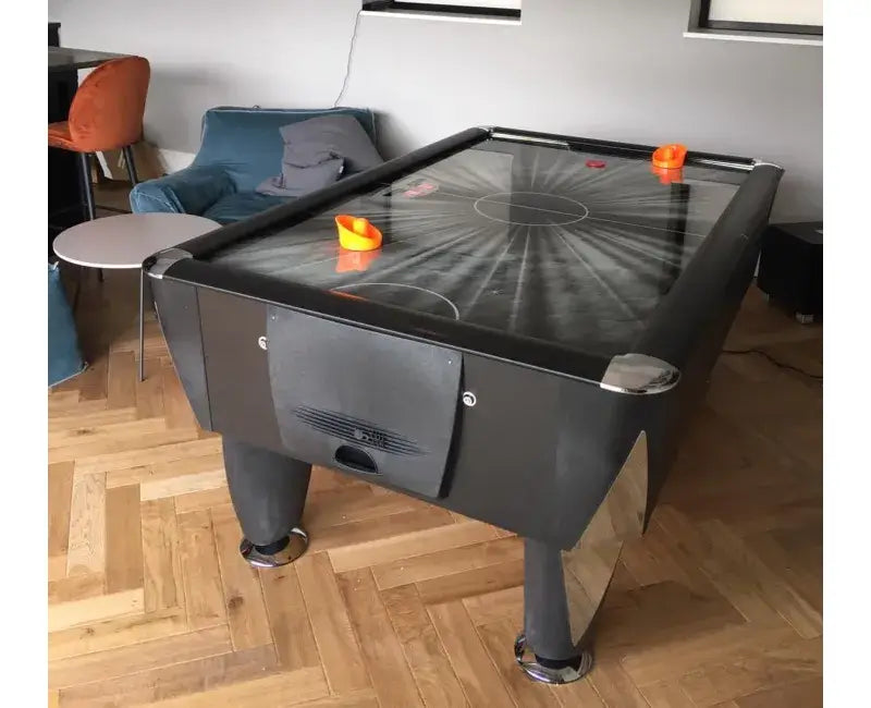 SAM Black Ice II air hockey table set up in a modern lounge
