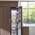 Signature Kitchen Suite integrated tall freezer open in a wood-panelled kitchen beside a window