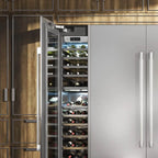 Signature Kitchen Suite integrated wine fridge column open beside a stainless steel fridge in wooden cabinetry