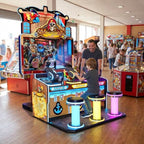 Skull of Shadow pirate shooting arcade machine in a UK seaside arcade with a child playing while a parent watches