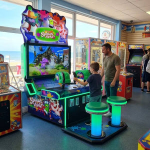 Splash Fight 2 player laser shooting arcade machine in a UK seaside arcade with a child playing while a parent watches