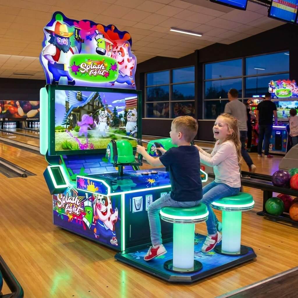 Two children playing Splash Fight at a bowling alley in the evening