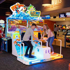 Two teenagers racing on Surf League at a bowling alley in the evening