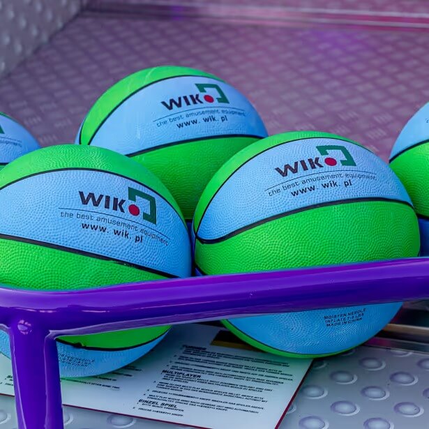 Green and blue basketballs in the ball tray of The Big Show arcade machine