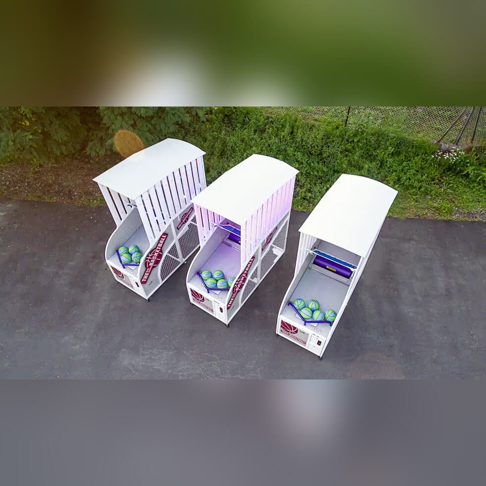 Three Big Show basketball arcade machines side by side outdoors