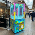 WIK Candy House claw machine in a shopping centre walkway next to a cafe