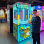 Teenager holding a small plush toy won from the WIK Candy House claw machine in a family entertainment centre