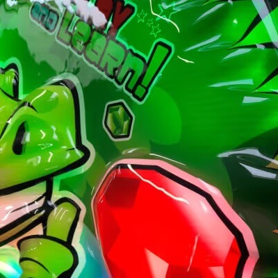 Close-up of the green dragon artwork on the Dragon Racer kiddie ride header