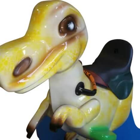Close-up of the yellow dinosaur figure with black saddle and reins