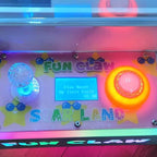 Close-up of the WIK Fun Claw control panel with joystick, lit button and display