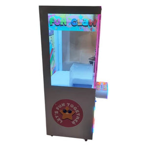 Side view of the WIK Fun Claw arcade claw machine showing the glass prize cabinet and star artwork