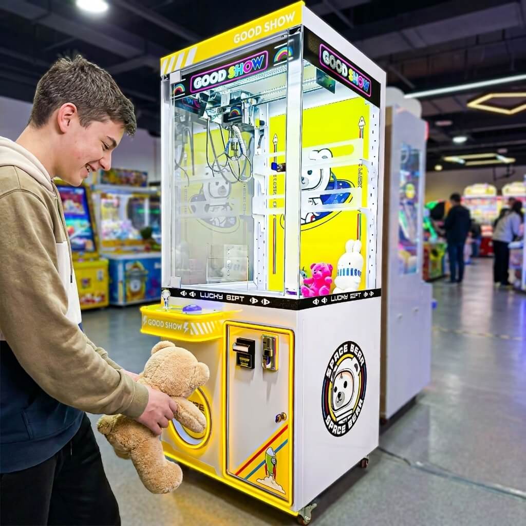 Teenager holding a teddy bear won from the WIK Good Show claw machine in a family entertainment centre