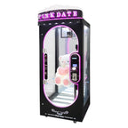 WIK Pink Date cut the string prize machine in black with lit crown-top sign and teddy bear prize