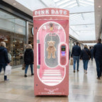 Pink WIK Pink Date prize machine in a shopping centre walkway next to a cafe