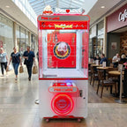 WIK Pink Love claw machine in a shopping centre walkway next to a cafe