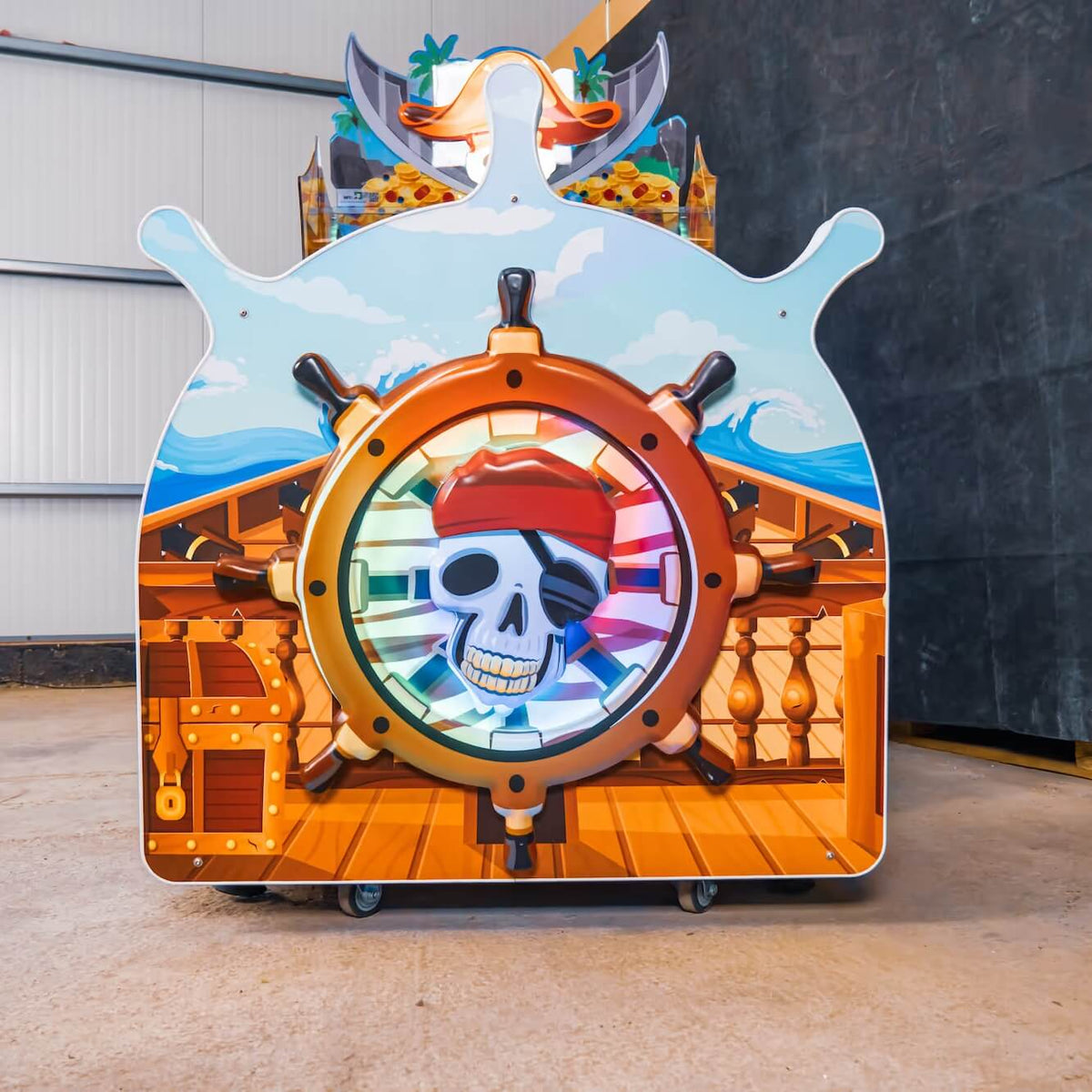 Ship's wheel and pirate skull on the back of the WIK Pirate Island arcade machine