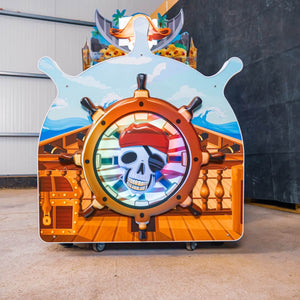 Ship's wheel and pirate skull on the back of the WIK Pirate Island arcade machine