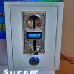 Coin acceptor on the front of the WIK Toy Star Mini claw machine with insert coin display