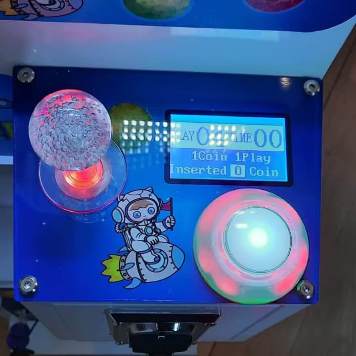 Close-up of the WIK Toy Star Mini control panel with lit joystick, button and display