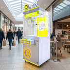 WIK Toy Star Small claw machine in a shopping centre walkway next to a cafe