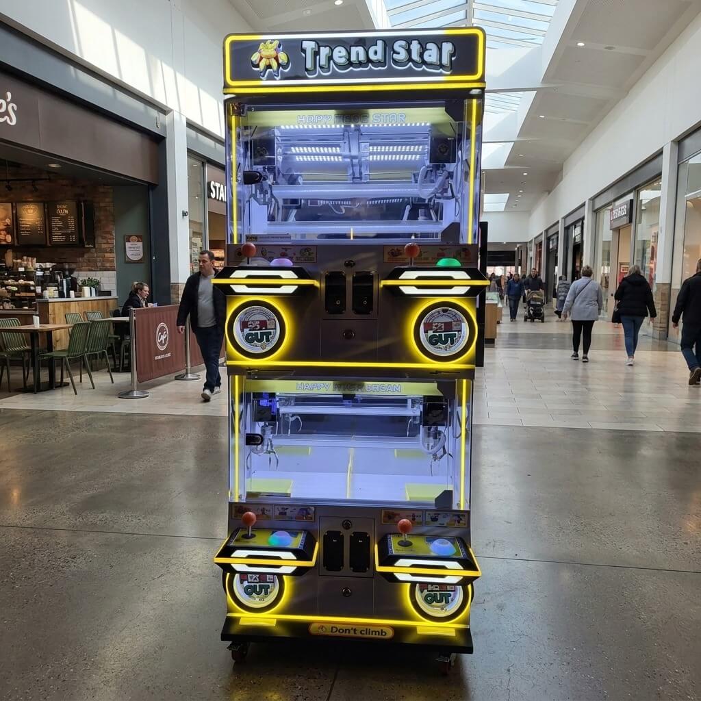 WIK Trend Star 4 player claw machine in a shopping centre walkway next to a cafe